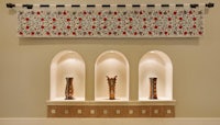 three vases on a shelf in a room