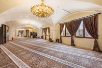 an ornate room with a chandelier and carpet