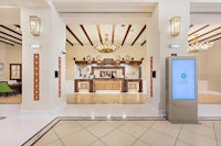 the lobby of a hotel with a chandelier